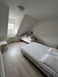 a bedroom with a large bed and a window at Maison de vacances accès direct plage residence sécurisée in Jullouville-les-Pins