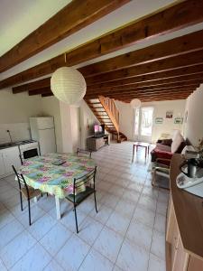 a kitchen and a living room with a table at Maison de vacances accès direct plage residence sécurisée in Jullouville-les-Pins +13 photos