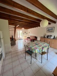 a kitchen and a dining room with a table and chairs at Maison de vacances accès direct plage residence sécurisée in Jullouville-les-Pins