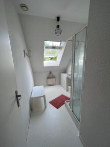 a small attic room with a skylight and a stool at Maison de vacances accès direct plage residence sécurisée in Jullouville-les-Pins