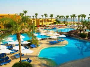 an overhead view of a resort pool with chairs and umbrellas at Stella Beach Resort & Spa Makadi Bay - 24 HRS All Inclusive in Hurghada