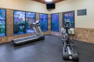a gym with a treadmill and a camera in a room at Super 8 by Wyndham O'Fallon in O'Fallon