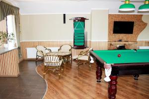a living room with a pool table and a tv at Family Complex EkoKomfort in Sagunovka