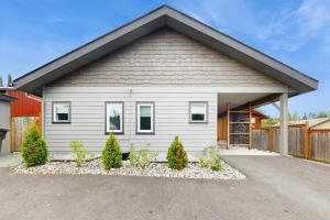 a white house with a garage at Modern Moose Hollow in Anchorage