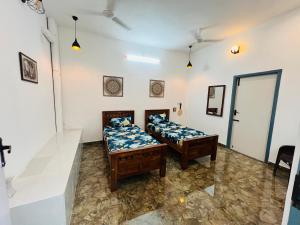 a room with two beds in a room at THEE Confort rooms in Pondicherry