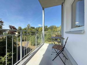 a balcony with a table and a chair on it at AM1237 moderne Monteurwohnung mit Balkon in Amberg