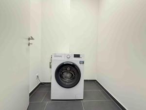 a washing machine in a corner of a room at AM1237 moderne Monteurwohnung mit Balkon in Amberg +5 photos