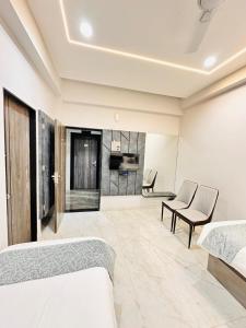 a bedroom with two beds and a living room at Hotel Diamond Executive in Solapur