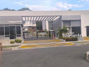 a building with a sign on the side of a street at Apartamento Alicante in Girardot +2 photos