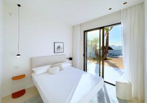 a white bedroom with a bed and a view of the ocean at Solemar Sicilia - Villa Gloria in Ficarazzi +16 photos
