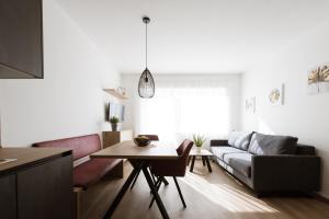 a living room with a couch and a table at Pension Kleon in Rifiano