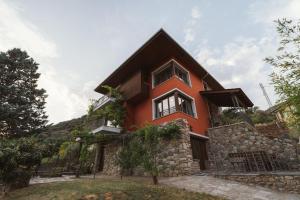 a red house on top of a hill at Masia Boutique con Infinity Pool in Calvinyá