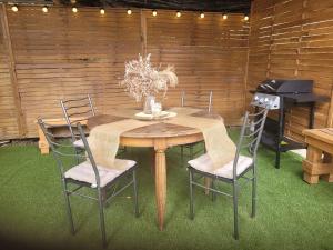 a dining room table with chairs and a piano at Love room avec jaccuzi privé in Perpignan