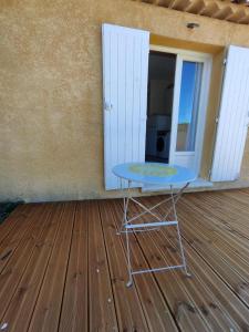 a blue table sitting on a wooden floor in a room at Studio Saint Maximin la Sainte baume in Saint-Maximin-la-Sainte-Baume +1 photo