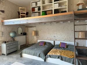 a bedroom with two bunk beds and a desk at La Bastide Montboyer - Grande maison au calme in Montboyer +15 photos
