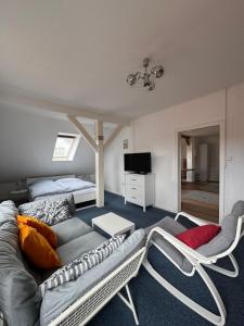 a living room with a couch and two chairs at Altes Zollhaus in Borkum