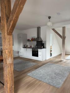 a kitchen with white cabinets and a stove at Altes Zollhaus in Borkum