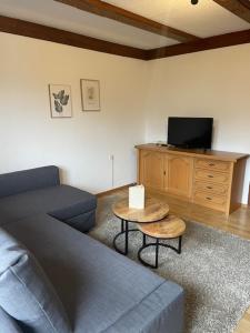 a living room with a blue couch and a table at May's Apartments & Restaurant in Obervellach