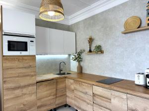 a kitchen with wooden counter tops and a sink at Las Dunas DM sea view in San Bartolomé de Tirajana