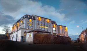 a building with yellow lights on the side of it at Maldron Hotel Shandon Cork City in Cork