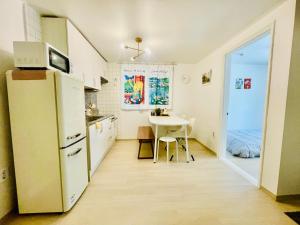 Una cocina con un refrigerador blanco y una mesa. en Sweet Breeze Stay Guesthouse, en Seúl 24 fotos más