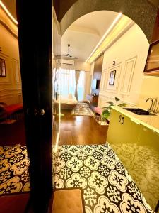 a room with a kitchen and a living room at Project Artisan's Retreat! in Ghaziabad