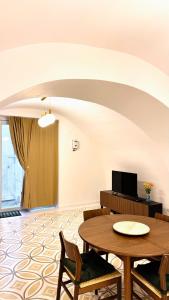 a living room with a table and chairs at Casa MAR e LUNA in Amalfi