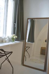 a mirror in a bathroom with a table and a window at Casa MAR e LUNA in Amalfi +22 photos