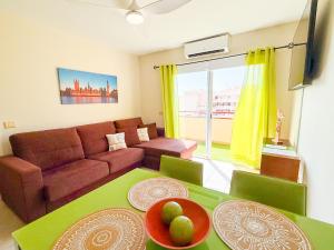 a living room with a couch and a table at Blue Ocean Oasis in Puerto de Santiago