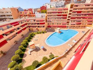 an aerial view of a building with a swimming pool at Blue Ocean Oasis in Puerto de Santiago