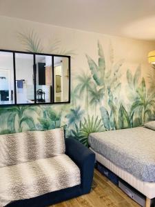 Ένα ή περισσότερα κρεβάτια σε δωμάτιο στο Appart hôtel au Pradet