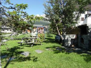 a park with a picnic table and a playground at Residence Nevegall by Original Galli in Livigno