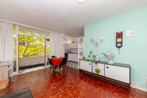 a living room with blue walls and a red chair at Central Urban Studio with Garden viewSwimming Pool in Cape Town