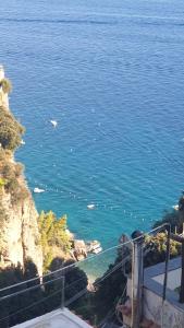 a view of the ocean from a balcony at Amalfi Rooms Duoglio Beach -amazing seaview in Amalfi +48 photos