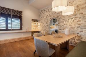 a dining room with a wooden table and chairs at Villa Alia in Makri