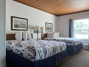 a hotel room with two beds and a window at Lantern Motel in Milbank