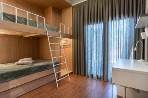 a bedroom with a bunk bed and a desk at Villa Alia in Mákri