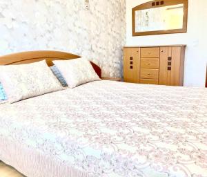 a bedroom with a large bed and a dresser at Apartment near the center Затишна квартира в центрі in Sumy