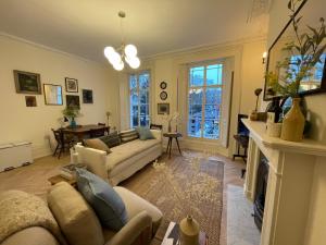 a living room with a couch and a fireplace at Beautiful & Central 1 Bedroom Flat in Clerkenwell in London