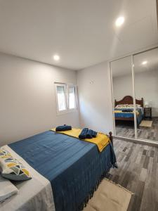 a bedroom with a large bed and a mirror at Marca 34 in Monção