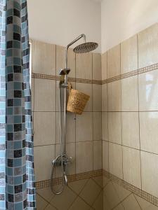 a shower with a shower head in a bathroom at Fole Maison in Durrës +27 photos