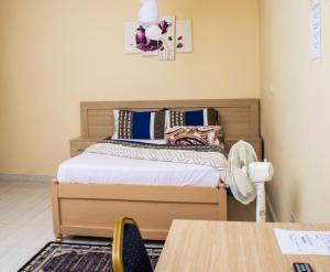 a bedroom with a bed and a table and a table sidx sidx at The Green City Premier Lodge in Zomba +48 photos