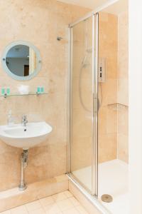 a bathroom with a shower and a sink at Deangate Motel in Lydney +80 photos