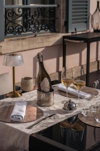a table with a bottle of wine and two glasses at Villa Eulalie - Champagne Edouard Duval B&B Guest House nestled in the Champagne area in Bligny