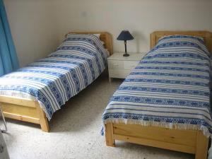 two beds sitting next to each other in a bedroom at Penthouse Apartment Latchi Cyprus in Lachi