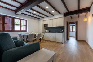 a living room with a couch and a table with chairs at Infinity Coast by Fidalsa in Miengo +78 photos