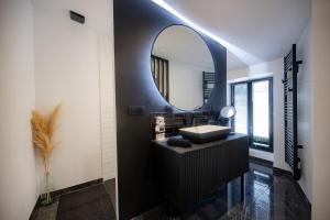 a bathroom with a sink and a mirror at INFINITY I Seventharts I Cinema room in Angoulême