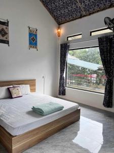 Ένα ή περισσότερα κρεβάτια σε δωμάτιο στο Ume Homestay