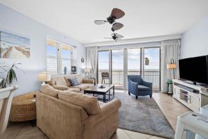 a living room with a couch and a tv at Waterfront PCB Condo with Balcony and Beach Gear! in Panama City Beach