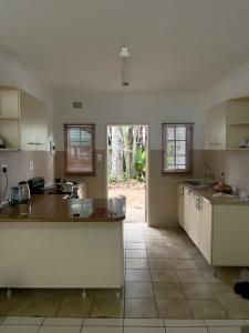 a kitchen with white cabinets and a counter top at A taste of tranquility in Lobamba
